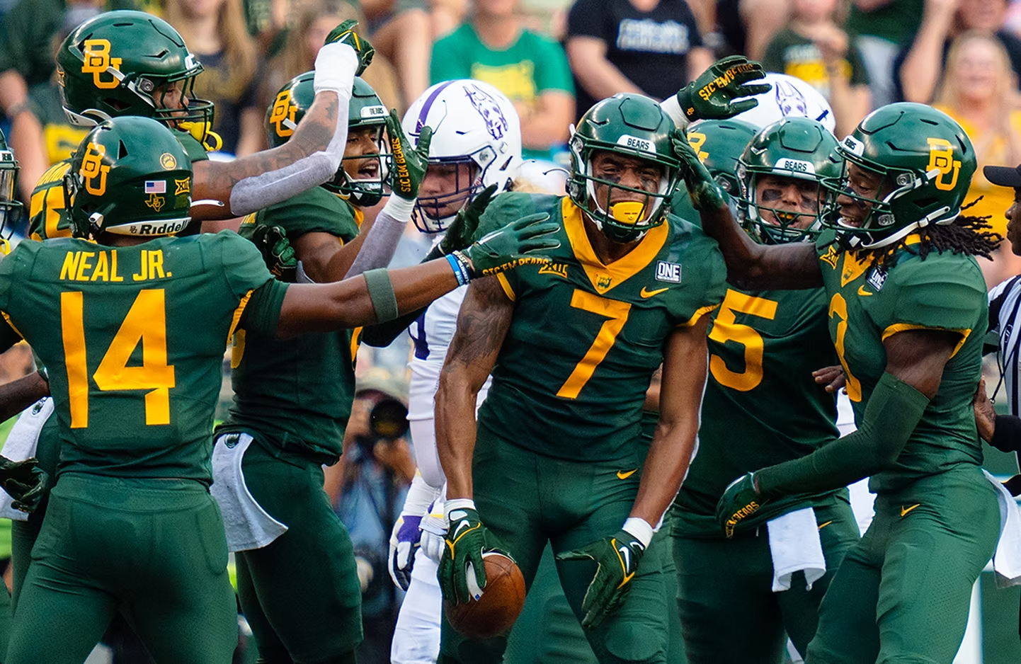 Baylor football players celebrating together on the field